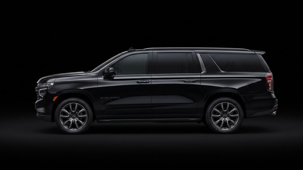 Black full-size SUV in profile against a dark background