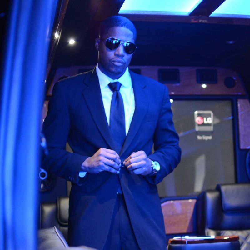 Quality Concierge Transportation chauffeur in a suit inside a luxury vehicle