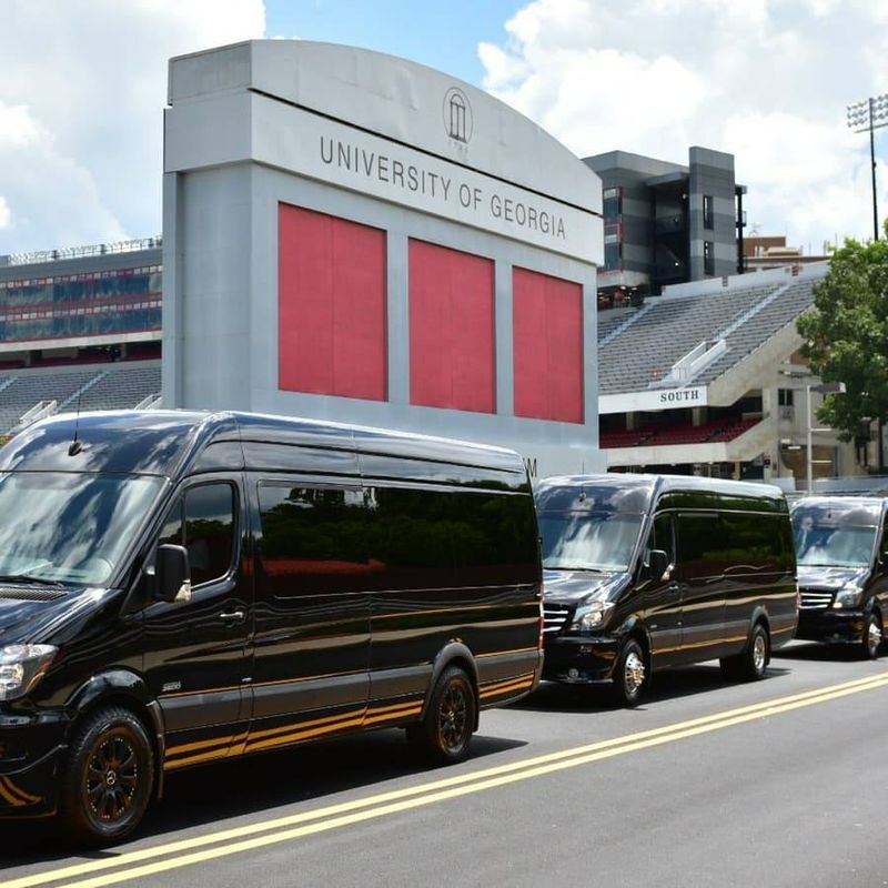 Quality Concierge Transportation Mercedes Sprinter vans lined up outside Sanford Stadium at the University of Georgia